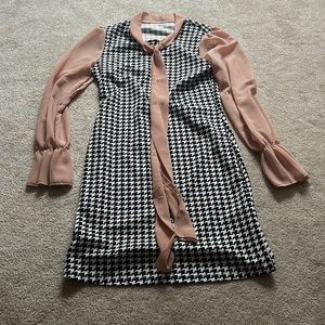This dress is from shein! Black and white houndstooth pattern with tan sleeves.